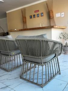 two chairs in a room with a counter at Pousada Vila Mar Japaratinga in Japaratinga