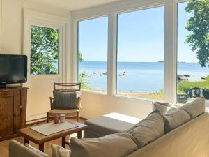 a living room with a couch and a view of the ocean at 6 person holiday home in SÖLVESBORG-By Traum in Sölvesborg