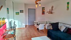 a living room with a couch and a table at Résidence les Antillannes in Gourbeyre +10 photos