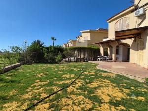 a house with a large yard in front of it at Coastal Comforts at Casabianca in Dawwār Muḩammad Abū Shanab