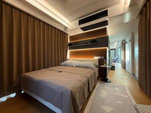 a bedroom with a large bed in a room at Futuristic Capsule - Private Jacuzzi & Beach access in Wapnica