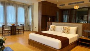 a bedroom with a large bed and a dining room at Terma Linca Paro in Paro