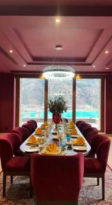 a long dining room with a long table with chairs at Terma Linca Paro in Paro