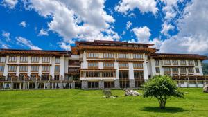 a large building with a green field in front of it at Terma Linca Paro in Paro