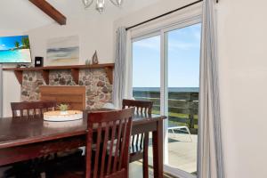 a dining room with a table and chairs and a window at Amethyst Dunes by Pristine Properties Vacation Rentals in Indian Pass