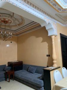 a living room with a couch and a table at Rayan in Tangier +2 photos