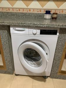 a washing machine under a counter in a kitchen at Rayan in Tangier
