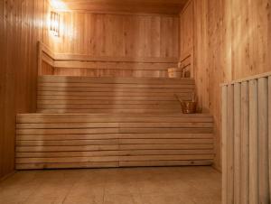 a sauna with wooden walls and stairs in a room at Lapsiņmuiža Pool House - Pool, Sauna & Hot-tub included in Dzedri