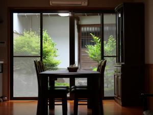 a table and chairs in a room with a window at 卌屋 shioya in Gujo