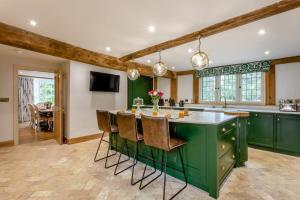 a kitchen with green cabinets and a large island at 11 Bed in Stebbing oc-p34450 in Stebbing