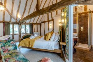 a bedroom with a bed in a room with wooden ceilings at 11 Bed in Stebbing oc-p34450 in Stebbing
