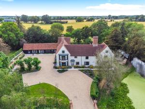 an aerial view of a large white house at 11 Bed in Stebbing oc-p34450 in Stebbing