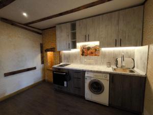 a kitchen with a sink and a washing machine at Rooms43 in Sofia