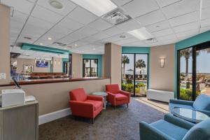 a waiting room at a hospital with red chairs at The Strand - A Boutique Resort in Myrtle Beach