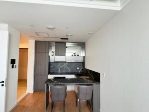 a kitchen with a table and chairs in a room at Mandala 365 Residential Tower in Ulaanbaatar