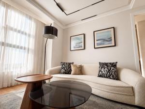a living room with a couch and a table at Mandala 365 Residential Tower in Ulaanbaatar