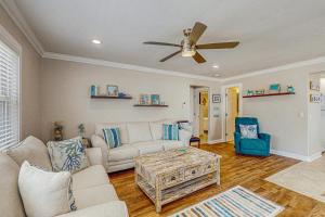 a living room with a couch and a ceiling fan at Sea Pirate 1 in Holmes Beach