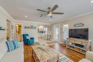 a living room with a couch and a flat screen tv at Sea Pirate 1 in Holmes Beach