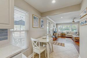 a kitchen and living room with a table and chairs at Sea Pirate 1 in Holmes Beach