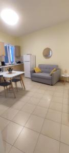 a living room with a couch and a table at Nicol's apartment in Ermoupoli