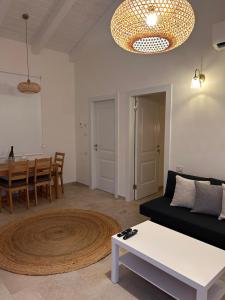 a living room with a couch and a table at בצל האורן Betzel haoren in El-Rom +9 photos