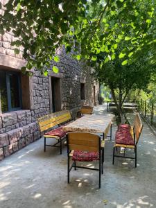a group of benches sitting in front of a building at Ikhtiyor guest house with mountainiring hiking horse riding serivices in Yukary-Ukhum