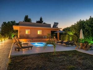 a villa with a swimming pool and a house at Summer Breeze Villa in Afantou