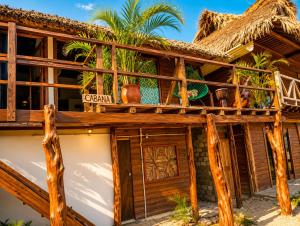 a resort building with a thatched roof at Siete Mares in Guayabas