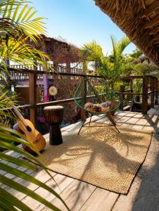a patio with a table and a chair and a guitar at Siete Mares in Guayabas