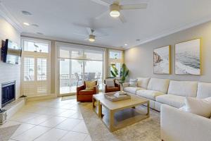 a living room with a couch and a table at Palm Gables 106 in Holmes Beach