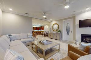 a living room with a couch and a table at Palm Gables 106 in Holmes Beach
