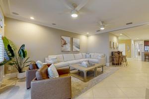 a living room with a couch and a table at Palm Gables 106 in Holmes Beach