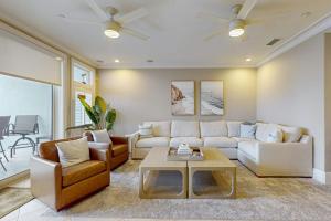 a living room with a couch and a table at Palm Gables 106 in Holmes Beach