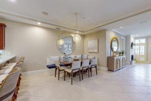 a dining room and living room with a table and chairs at Palm Gables 106 in Holmes Beach +31 photos