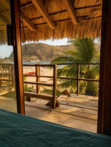 a view of the beach from a porch of a resort at Siete Mares in Guayabas +2 photos