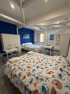 a bedroom with two beds and two tables in it at La Conchiglia 2.0 in Soverato Marina
