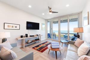 a living room with a couch and a tv at Hidden Cove Unit 6 in Holmes Beach