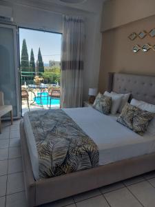 a bedroom with a bed with a view of a balcony at Maria Studios in Paleokastritsa