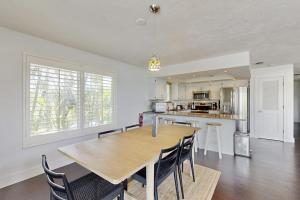a large kitchen with a wooden table and chairs at Spring Oasis in Anna Maria