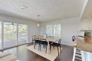a kitchen and dining room with a table and chairs at Spring Oasis in Anna Maria