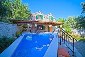 a house with a swimming pool in front of a house at Villa Valentina with pool and close to beach in Selca