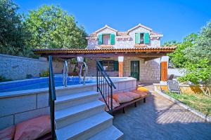 a house with a swimming pool next to a house at Villa Valentina with pool and close to beach in Selca