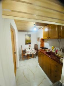 a kitchen with a table and a dining room at Guest House Castle in Koman