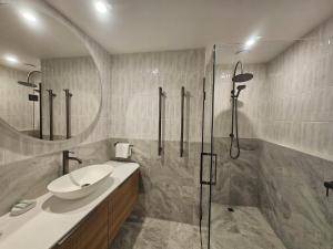 a bathroom with a sink and a shower at St James Apartments in Queenstown +100 photos