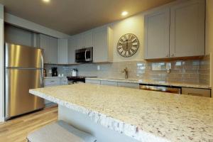 a kitchen with a counter top and a clock on the wall at South Bay Inn 1 in Anna Maria