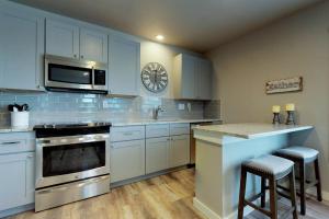 a kitchen with blue cabinets and a clock on the wall at South Bay Inn 1 in Anna Maria
