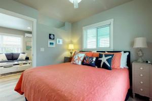 a bedroom with a bed with orange sheets and pillows at South Bay Inn 1 in Anna Maria