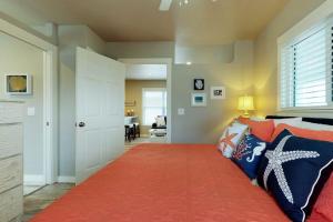 a bedroom with a bed with an orange rug at South Bay Inn 1 in Anna Maria
