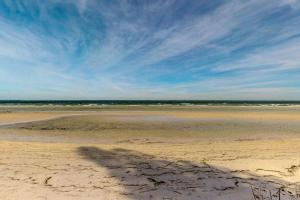a sandy beach with the ocean in the background at South Bay Inn 1 in Anna Maria +25 photos