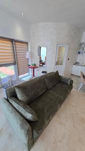 a living room with a large couch in the middle at CANj LOUNGE STUDIO in Čanj